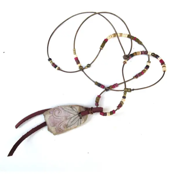 Secret poétique: un collier pour un sourire dans les yeux avec cette superbe céramique primitive