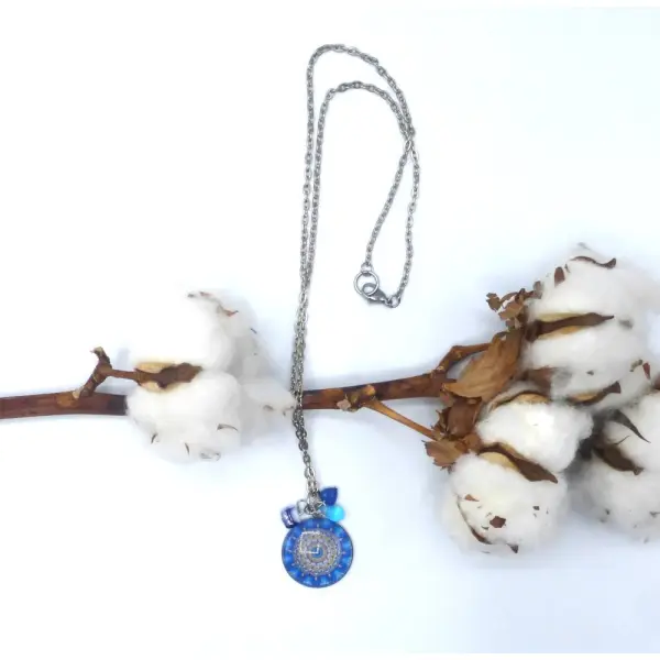 Pendentif rond fleurs bleu en cabochon en verre et acier inoxydable